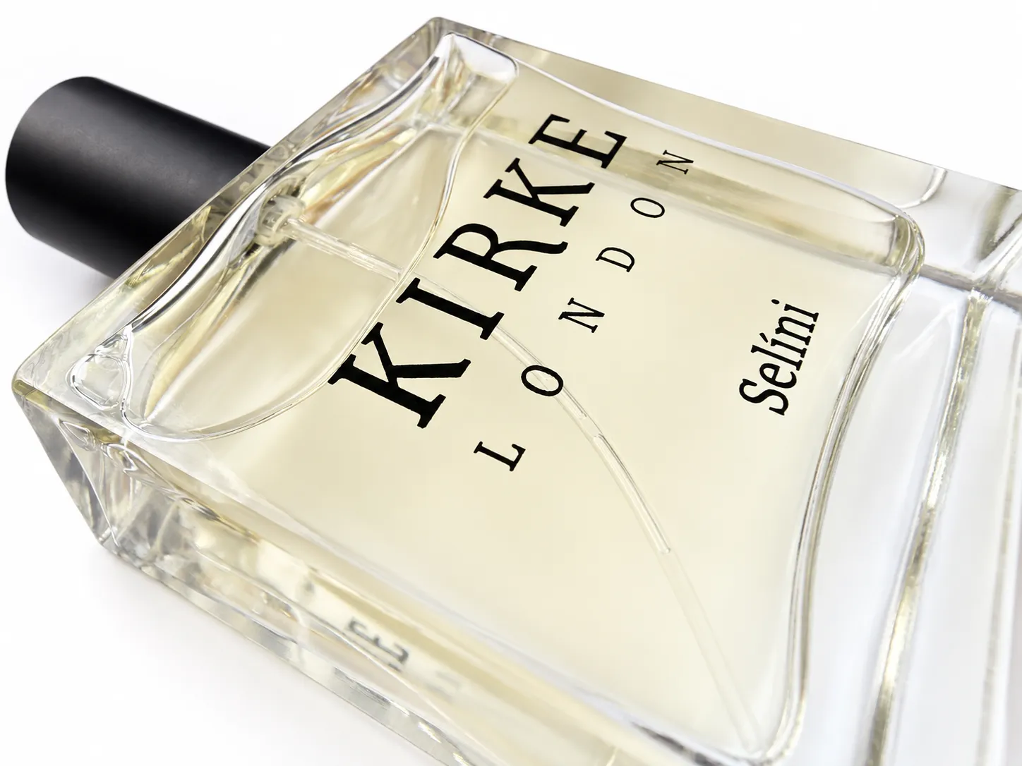 A macro detail of the Selíni bottle: bevelled glass, pale gold liquid and the Kirke London mark.